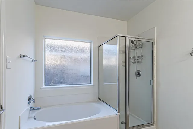 a bathroom with a bathtub and a shower