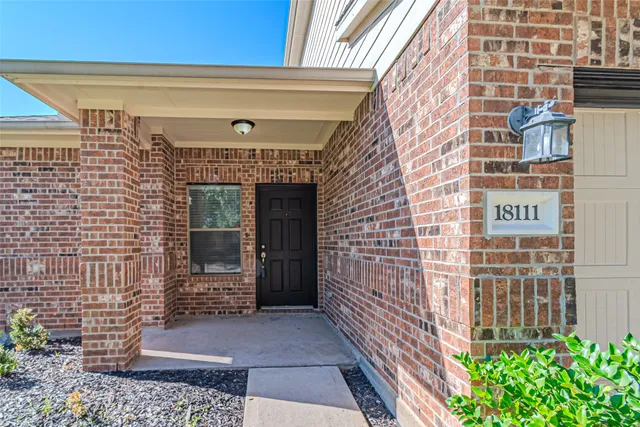 a front view of a building with a garden