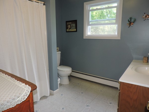 9 Hunter Hill Road Monson, MA 01057 - Photo 20 of 26 a bathroom with a granite countertop sink and a toilet