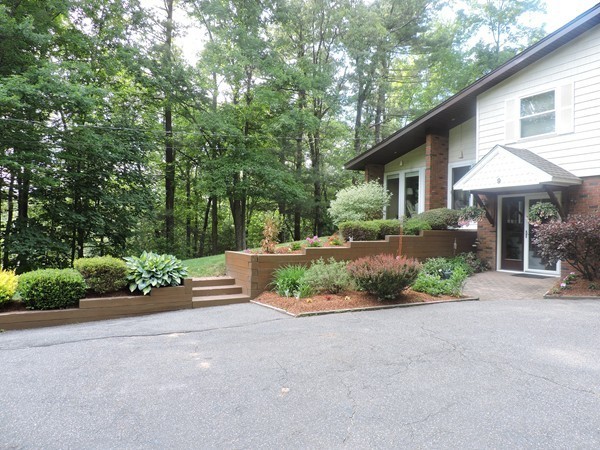 9 Hunter Hill Road Monson, MA 01057 - Photo 23 of 26 a front view of a house with a yard and outdoor seating
