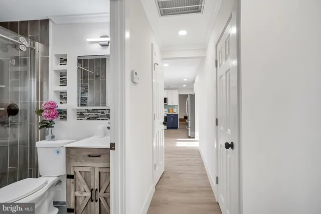 a en suite bathroom with a sink shower and a mirror