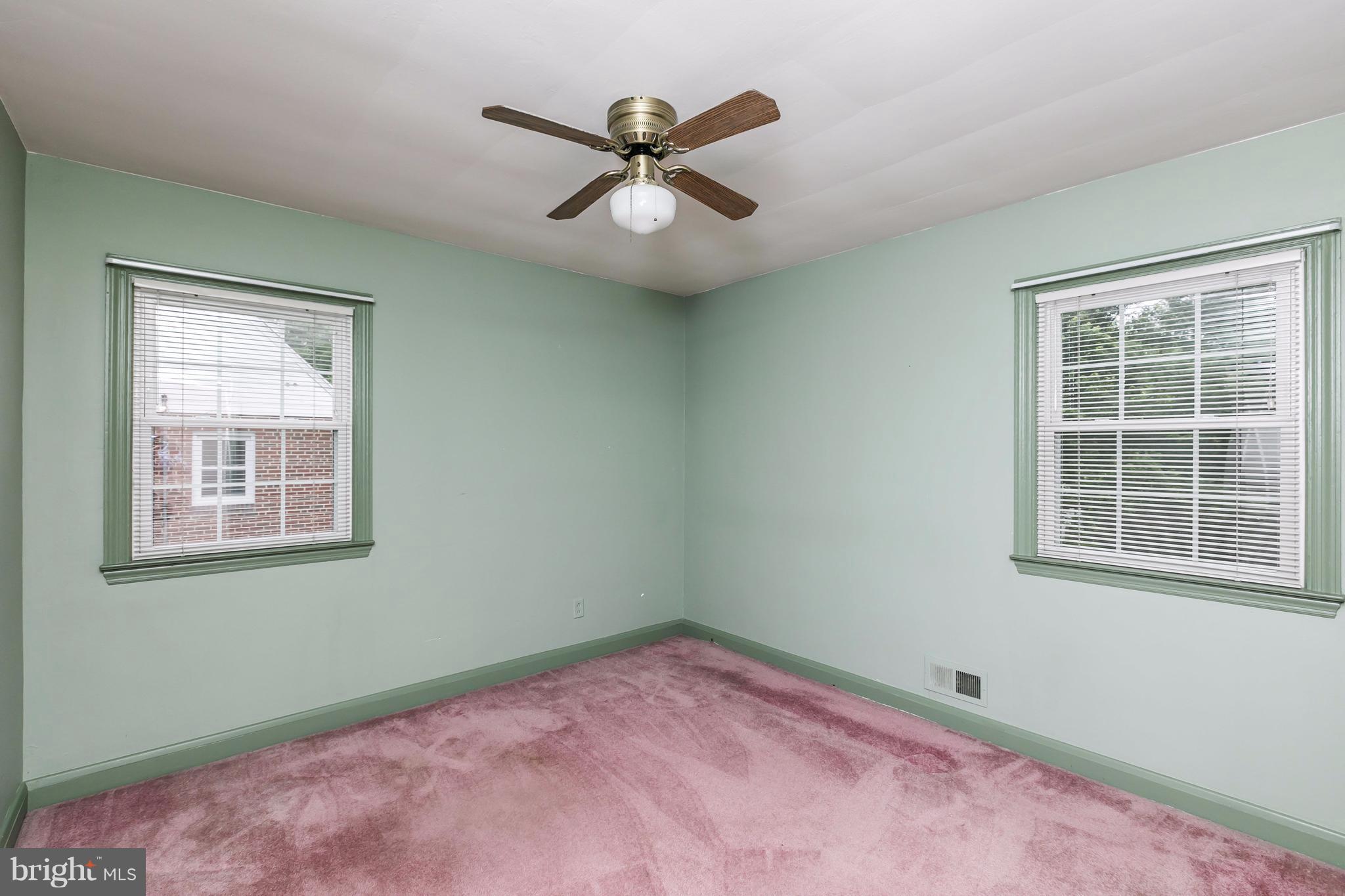 3629 Eitemiller Road Baltimore, MD 21244 - Photo 5 of 22 an empty room with a window and a ceiling fan