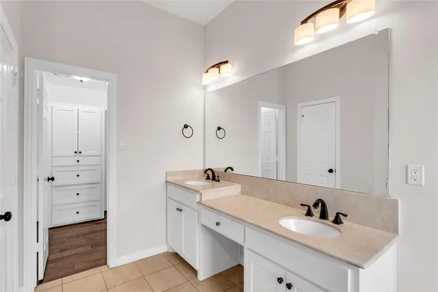 a bathroom with 2 sink tub double vanity and mirror