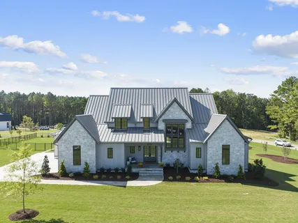 a front view of a house with swimming pool having outdoor seating