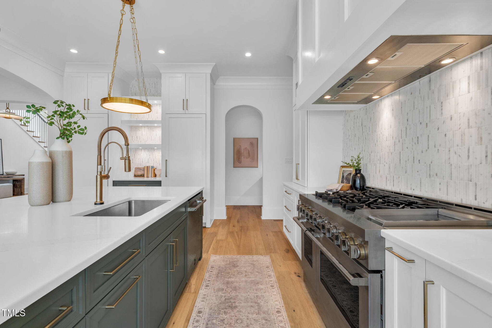 8917 Grand Highland Way Wake Forest, NC 27587 - Photo 16 of 80 a kitchen with stainless steel appliances granite countertop a sink a stove and a wooden floors