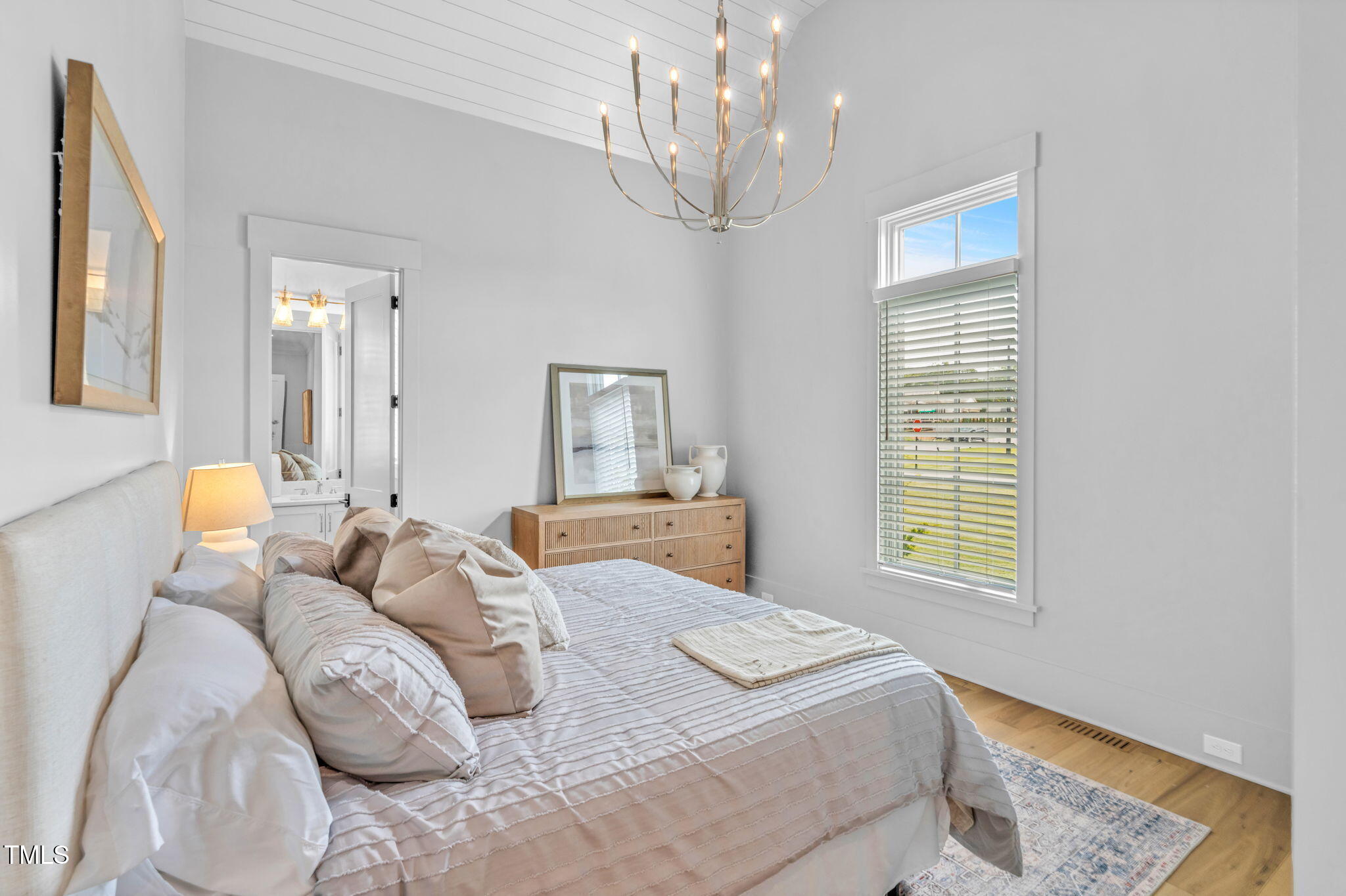 8917 Grand Highland Way Wake Forest, NC 27587 - Photo 38 of 80 a bedroom with a bed and a chandelier