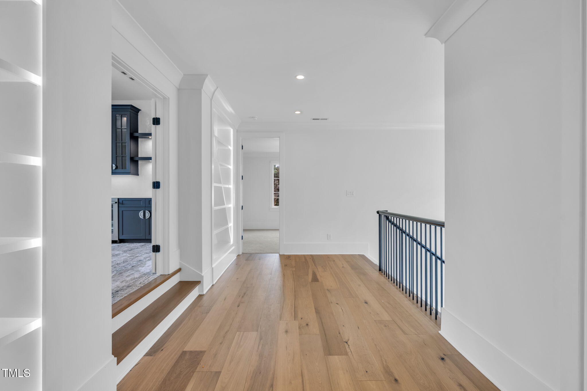 8917 Grand Highland Way Wake Forest, NC 27587 - Photo 40 of 80 a view of a hallway with wooden floor and a bathroom