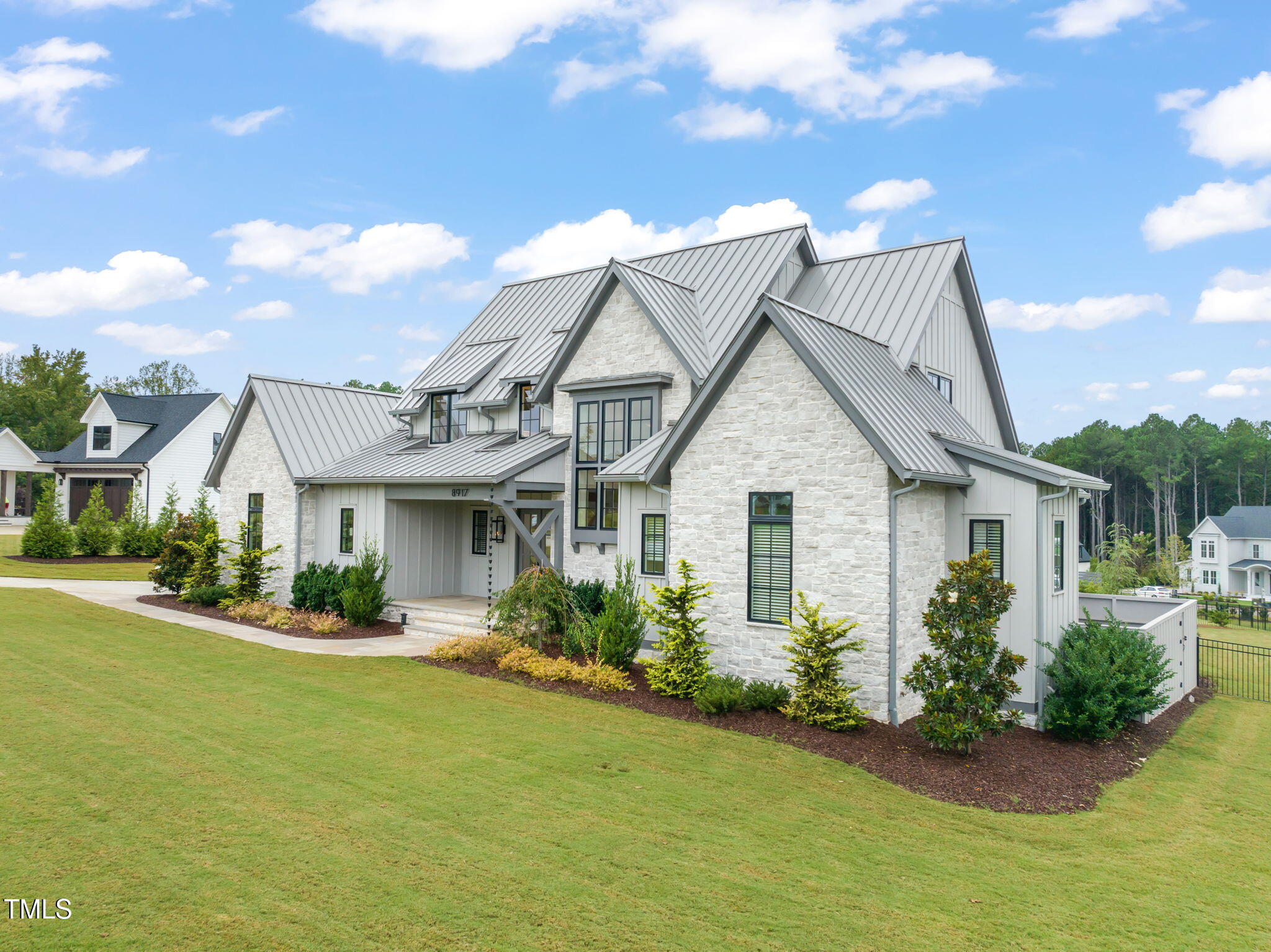 8917 Grand Highland Way Wake Forest, NC 27587 - Photo 72 of 80 a front view of a house with garden