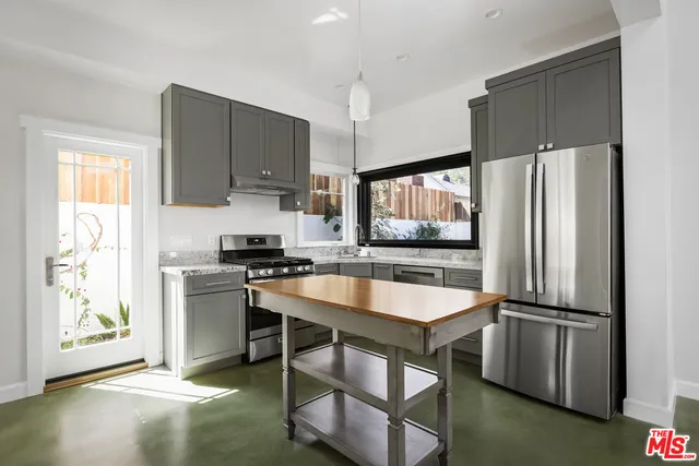 a kitchen with stainless steel appliances a stove a sink dishwasher and a refrigerator