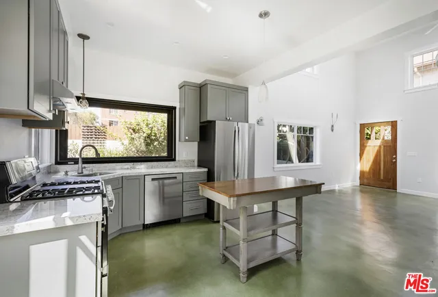 a kitchen with stainless steel appliances a stove sink and refrigerator