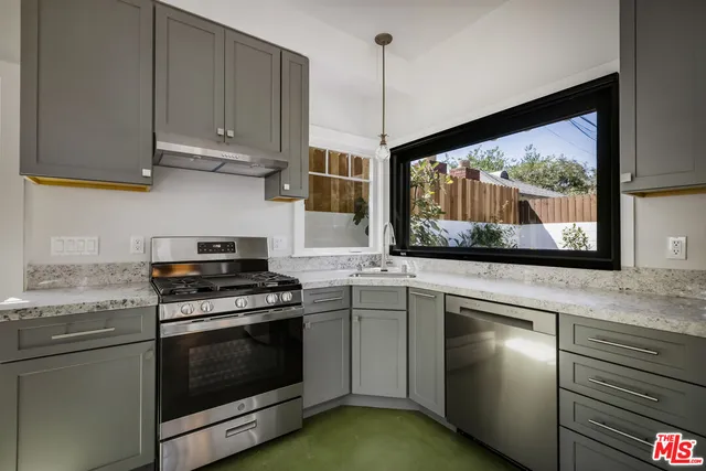 a bathroom with a granite countertop sink and mirror