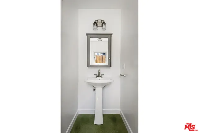 a view of a hallway with wooden floor and entryway