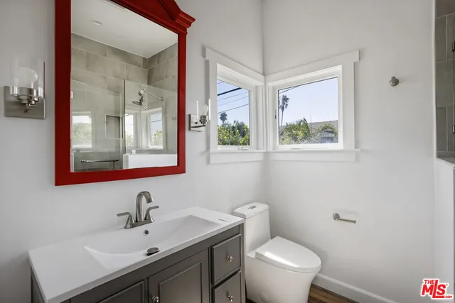 a bathroom with a toilet sink and mirror