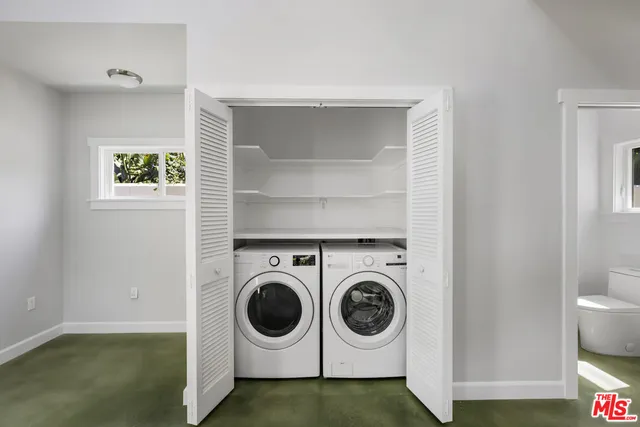 a kitchen with appliances a sink and cabinets