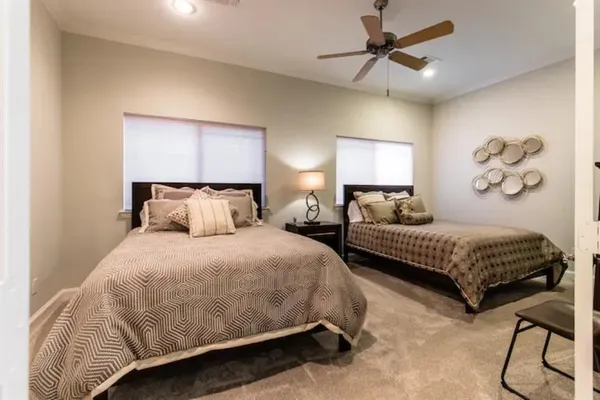 a bedroom with bed and a chandelier