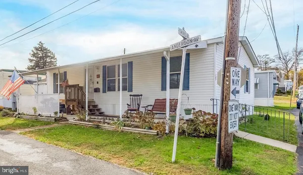 a view of a house with backyard swimming pool and sitting area