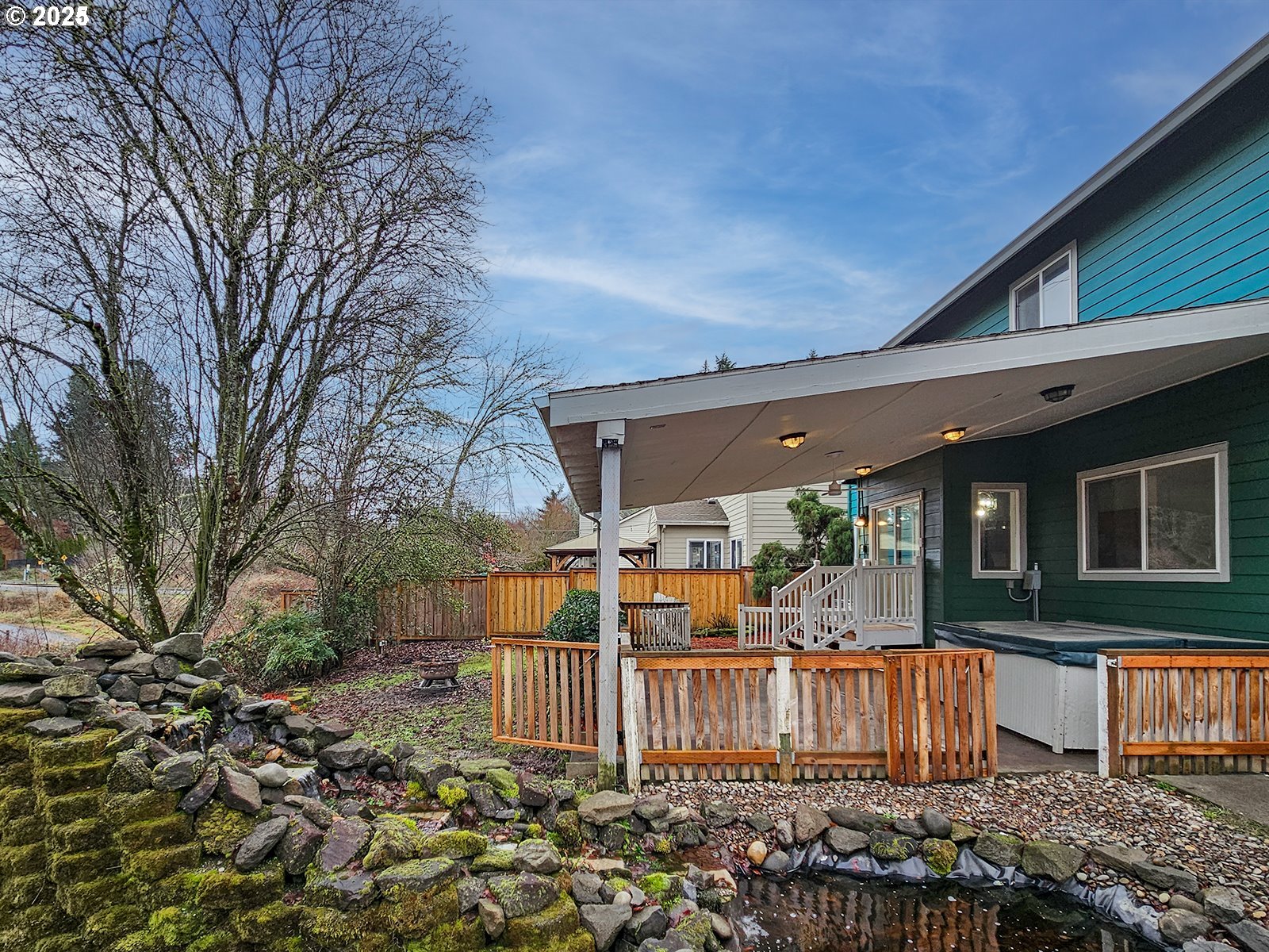 8754 Southwest Wakkila Terrace Beaverton, OR 97007 - Photo 17 of 19 a view of a house with a wooden fence