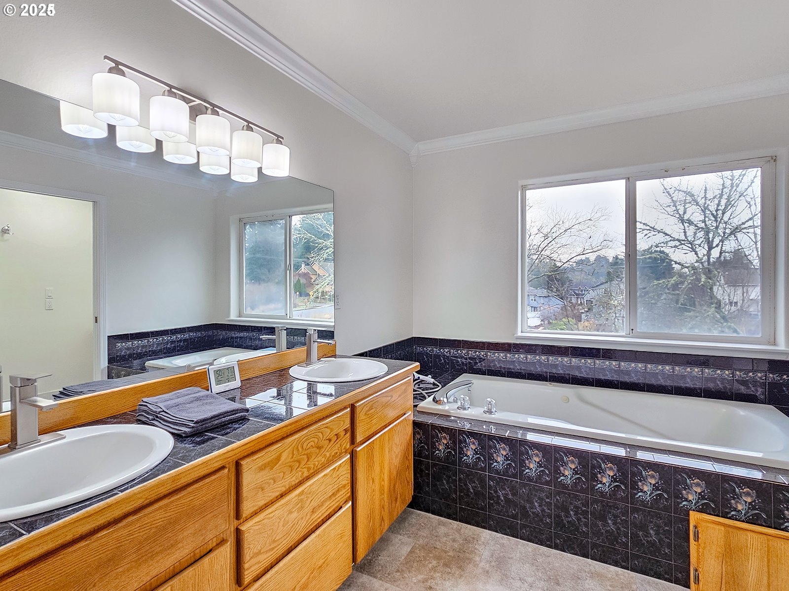 8754 Southwest Wakkila Terrace Beaverton, OR 97007 - Photo 5 of 19 a bathroom with a tub sink and mirror