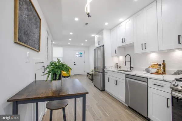 a kitchen with sink a microwave and cabinets