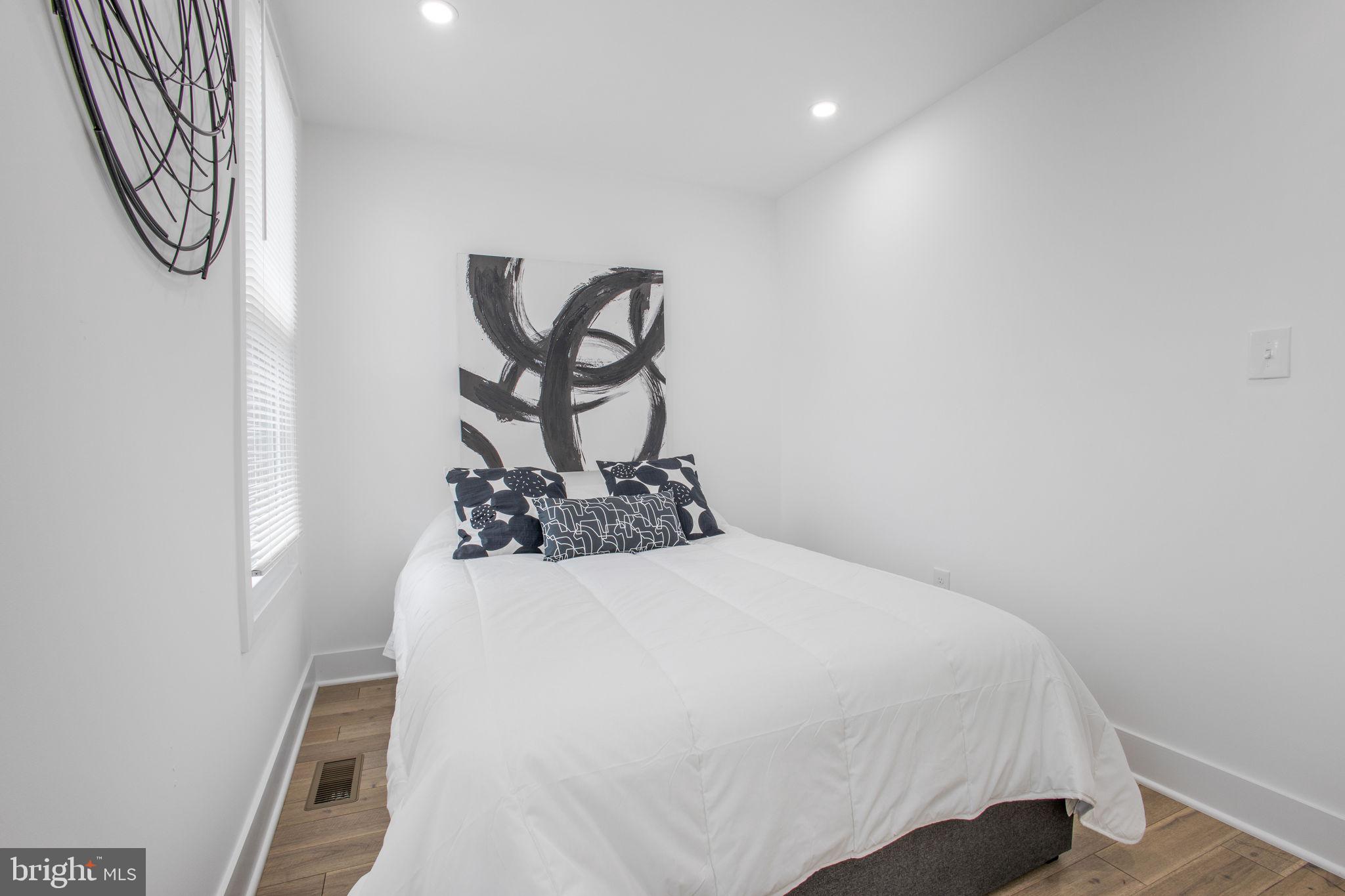 702 19th Street Northeast Washington, DC 20002 - Photo 17 of 38 a bedroom with a bed and a chandelier