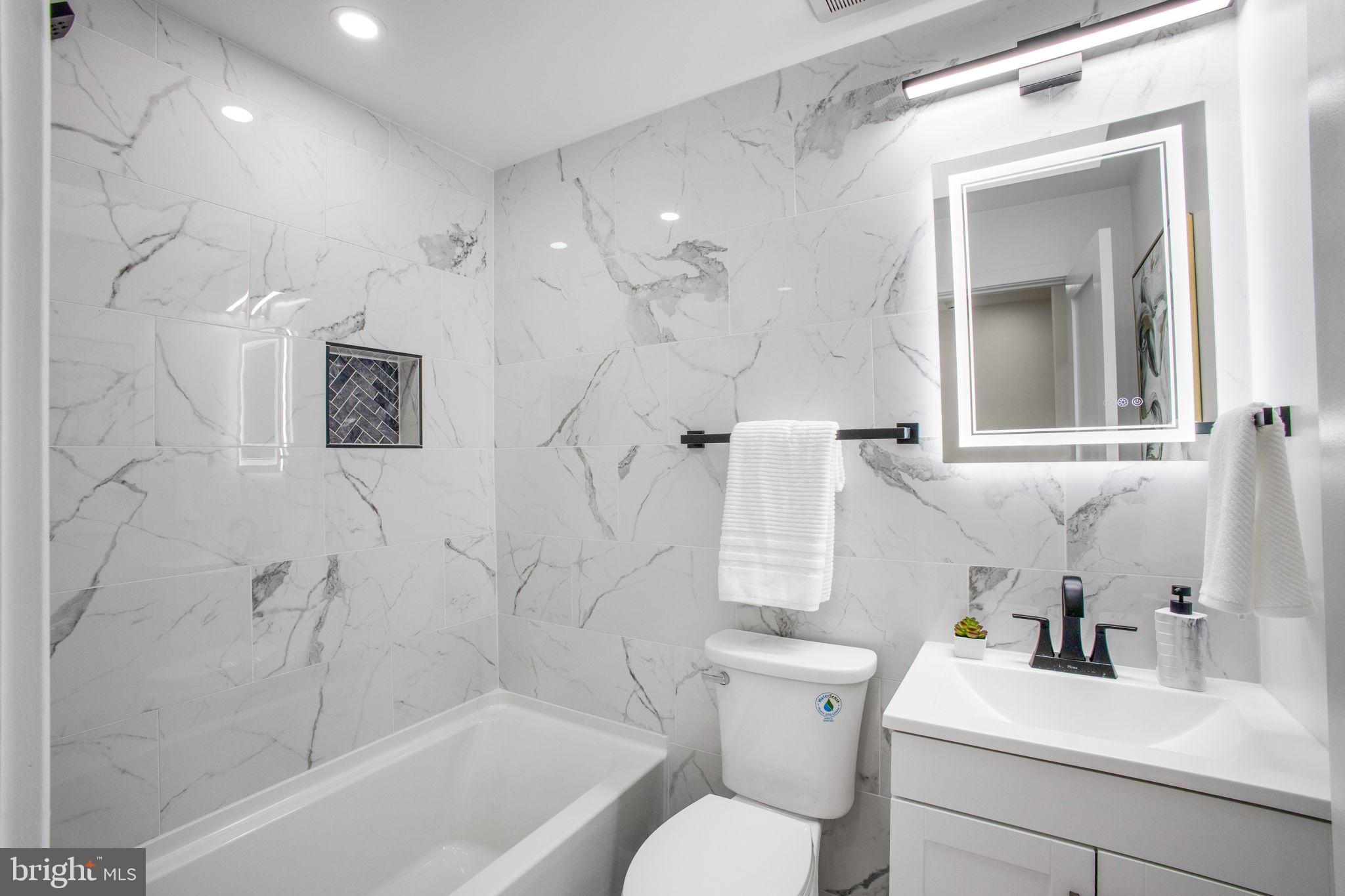 702 19th Street Northeast Washington, DC 20002 - Photo 19 of 38 a bathroom with a sink toilet and shower