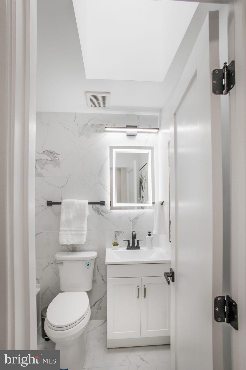 702 19th Street Northeast Washington, DC 20002 - Photo 24 of 38 a bathroom with a sink a toilet and shower