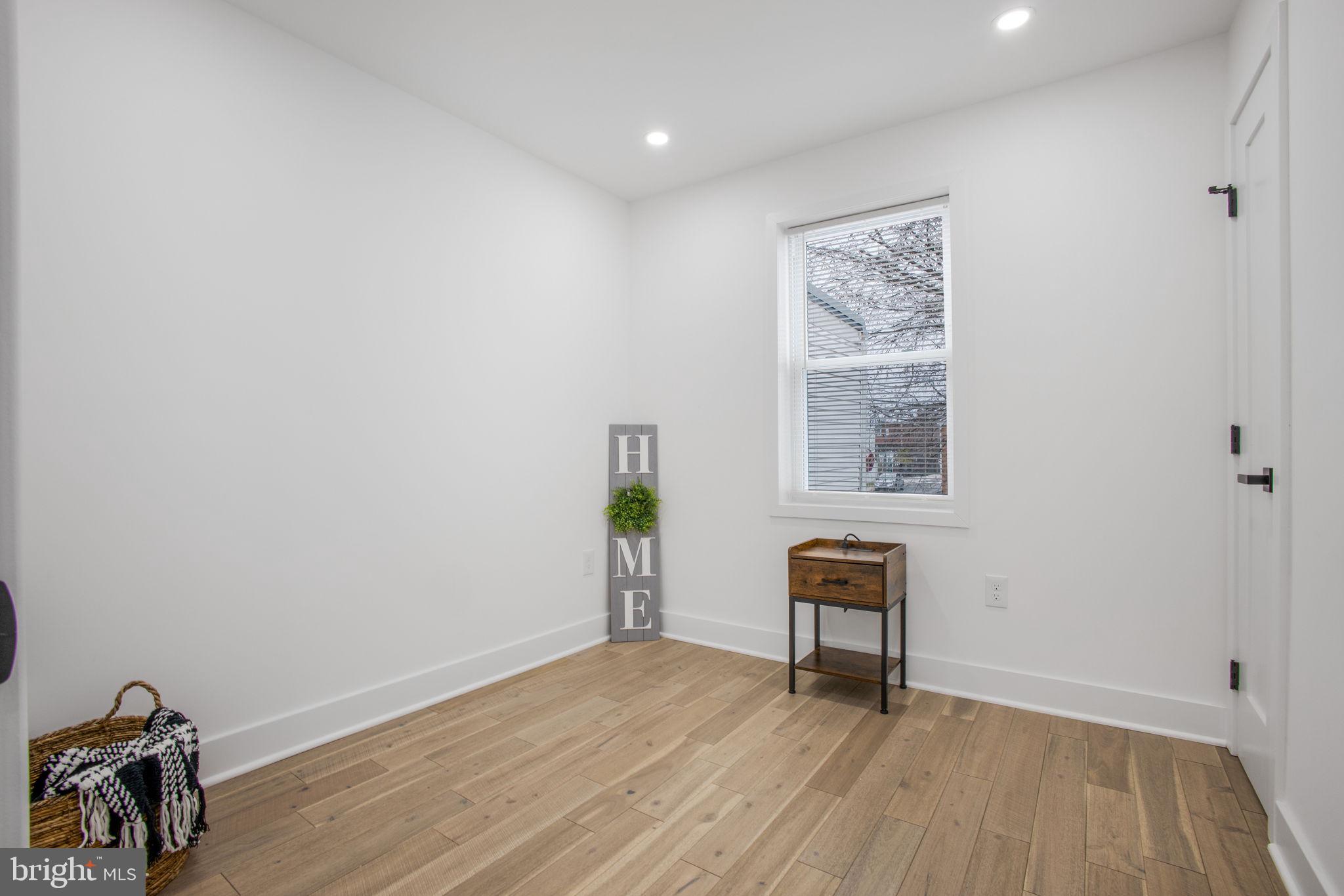 702 19th Street Northeast Washington, DC 20002 - Photo 25 of 38 a view of a hallway with wooden floor and a window