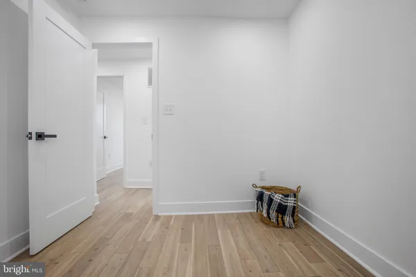 a view of room with wooden floor and a window
