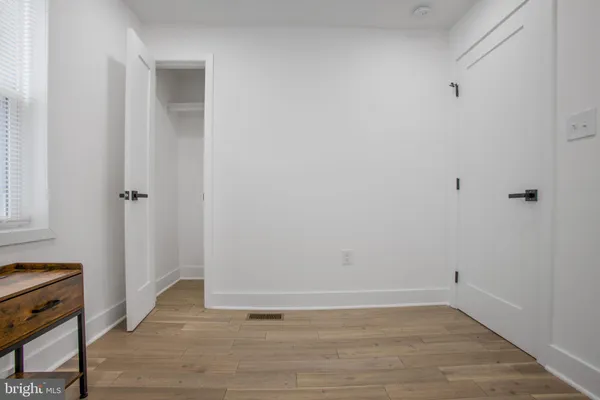 a view of a room with wooden floor