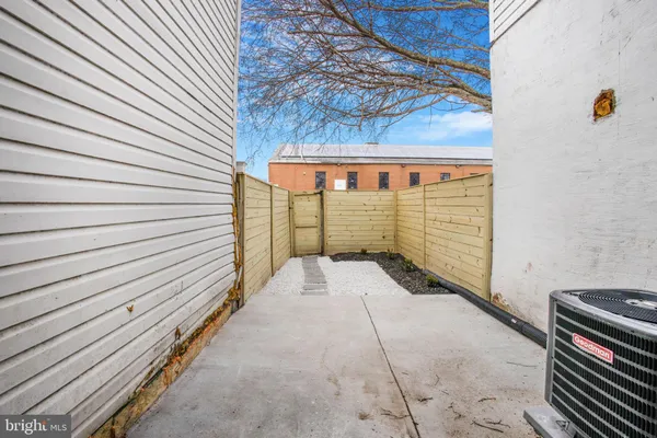 a view of backyard with a wooden fence