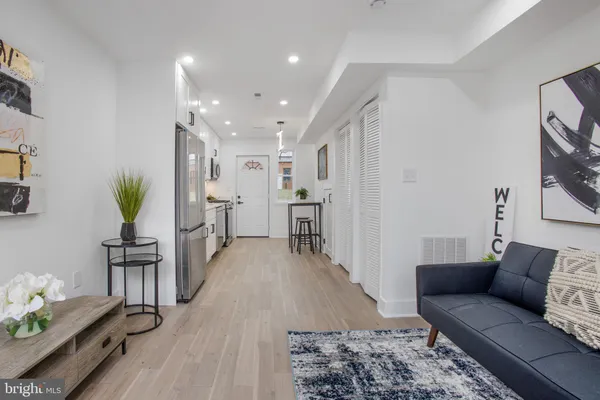 a living room with furniture and wooden floor