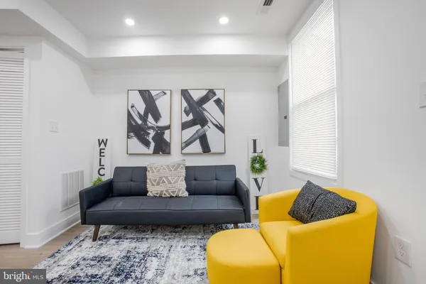 a living room with furniture and a rug