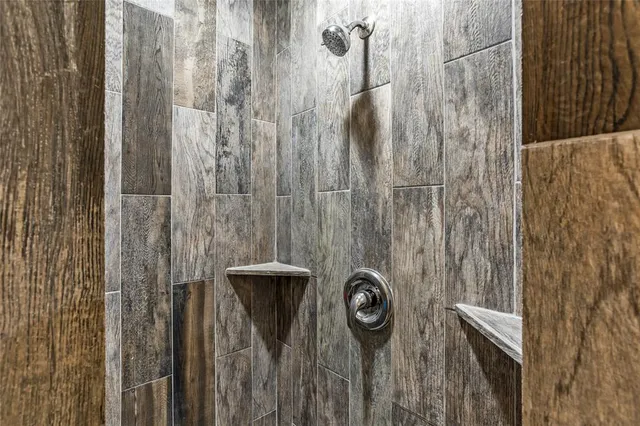 a bathroom with a shower and a sink