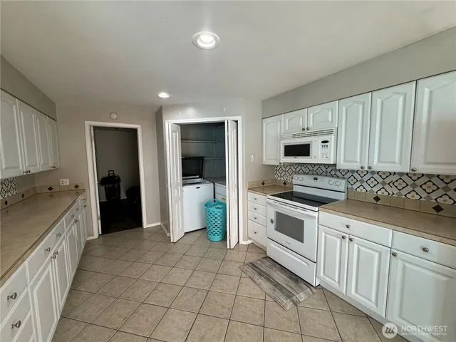 a large kitchen with white cabinets
