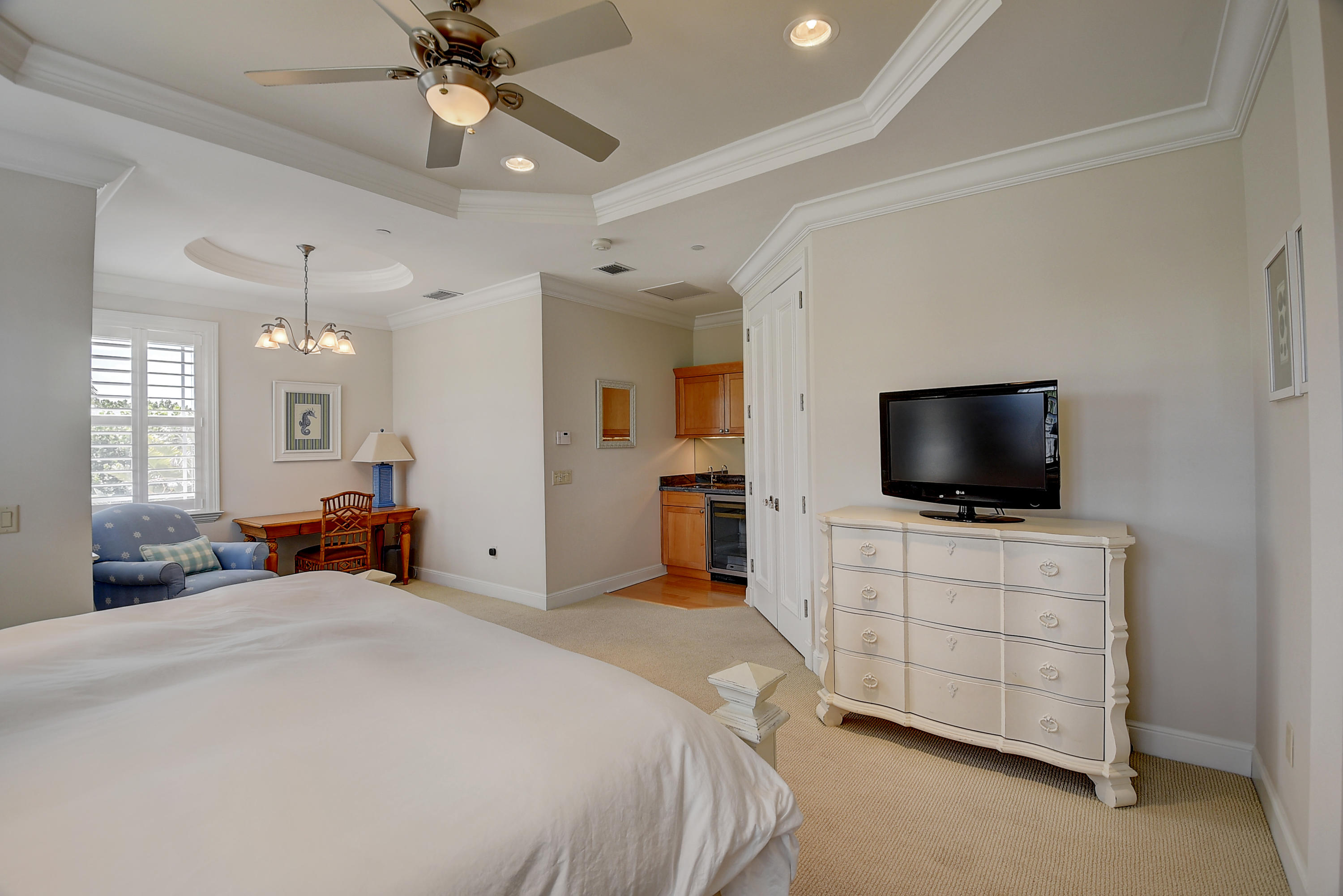1120 Ocean Terrace Delray Beach, FL 33483 - Photo 26 of 47 a bedroom with a bed and a flat tv screen on dresser