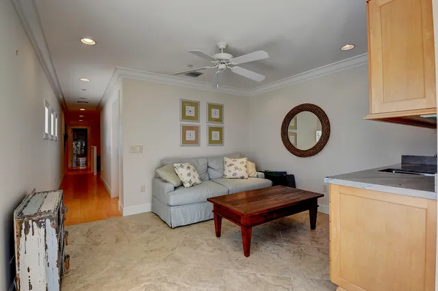 a living room with furniture and a clock