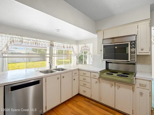 a kitchen with stainless steel appliances a stove sink and cabinets