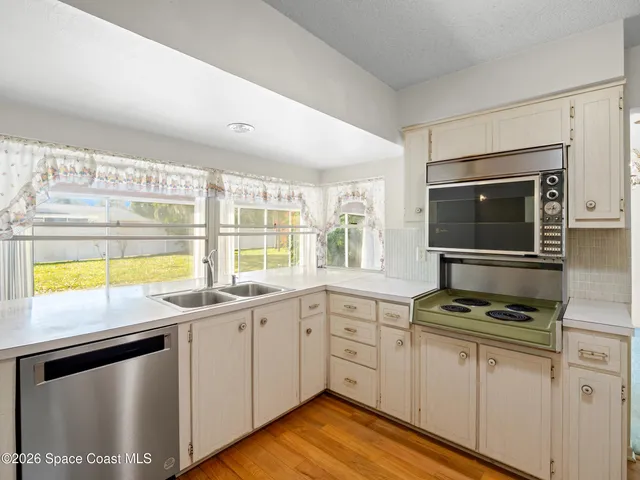 a kitchen with stainless steel appliances a stove sink and cabinets