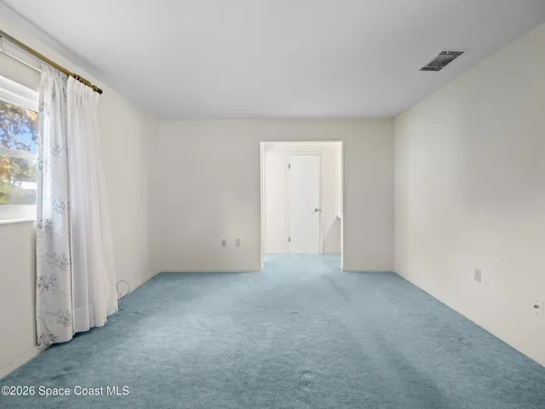 a view of an empty room and a window