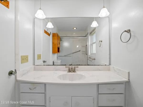 a bathroom with a sink vanity and a mirror