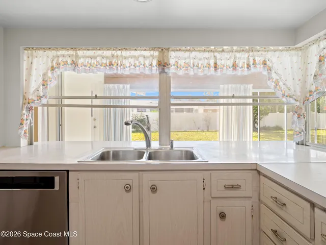 a kitchen with stainless steel appliances a sink and a window