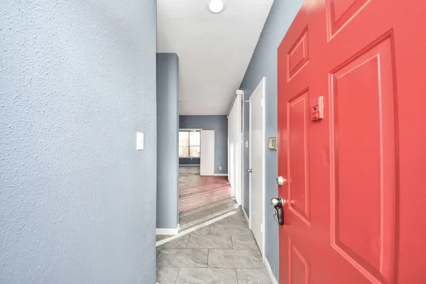 a view of a hallway with wooden shelves