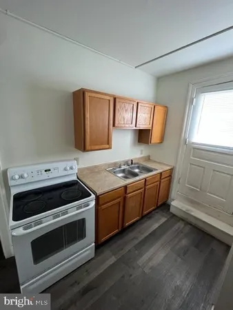 a kitchen with stainless steel appliances a stove a sink and a microwave
