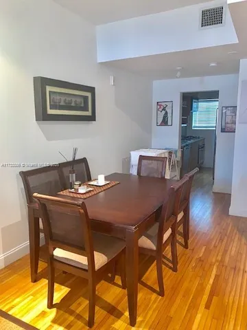 a dining room with furniture and wooden floor