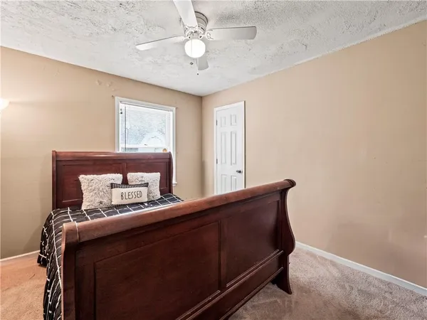 a room with a bed and a dresser