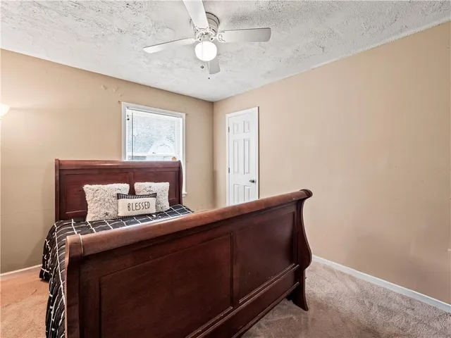 a room with a bed and a dresser