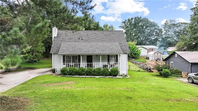 a view of a house with garden and yard