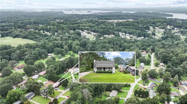 an aerial view of a house with a yard and lake view