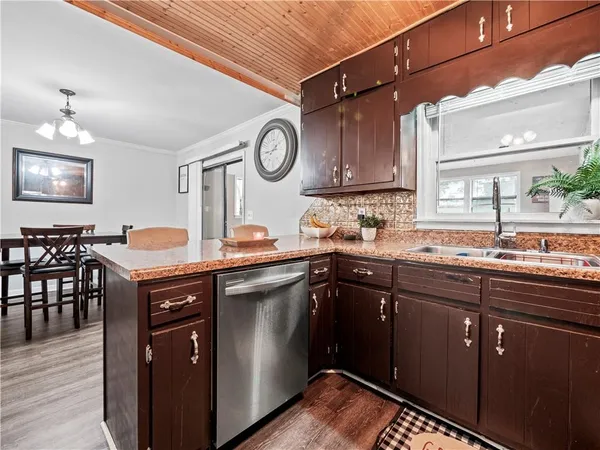 a kitchen with a sink cabinets and wooden floor