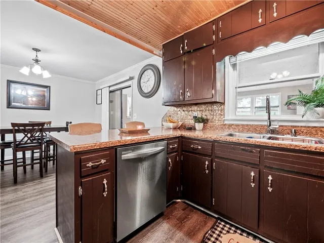 a kitchen with a sink cabinets and wooden floor